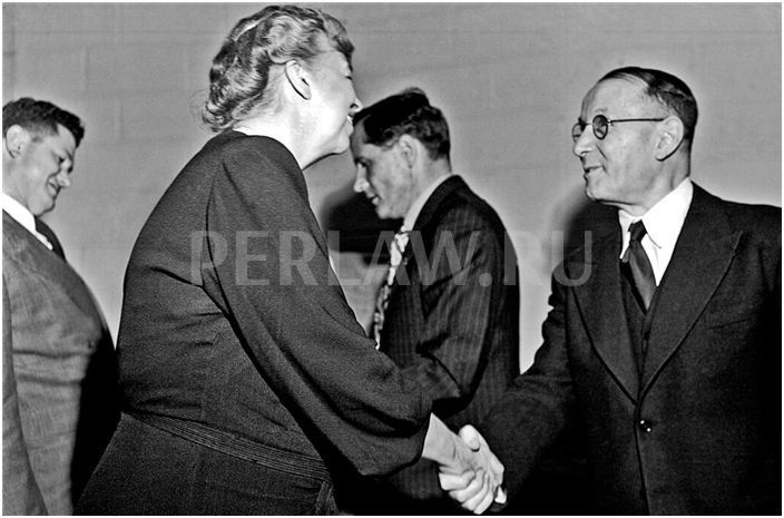 Eleanor Roosevelt of the US, at left, shaking hands with Vladimir M. Koretsky of the USSR, at right.